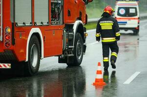 Highway Traffic Accident Site Firefighter Securing Traffic photo