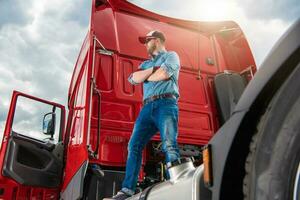 Proud Trucker and His Brand New Semi Truck Tractor photo