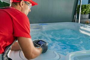 Garden SPA Technician Testing Hot Tub Remote photo