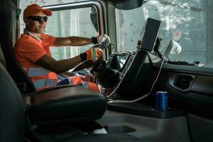 Caucasian Garbage Truck Driver Behind the Wheel photo