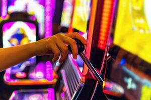 Woman Playing One Handed Casino Slot Game photo