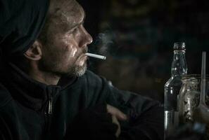 Homeless Men with Cigarette and Bottle of Vodka photo