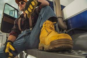 Truck Driver Resting Outdside Of Vehicle Cab. photo