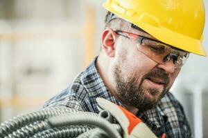 Caucasian Electric Contractor Worker with Electric Conduit photo