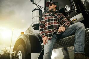 Professional Truck Driver Next to His Semi Tractor photo