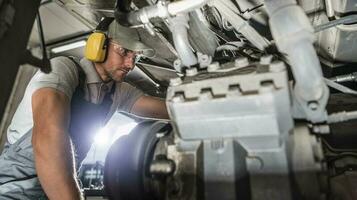 Industry Mechanic Performing Diesel Pusher Maintenance photo