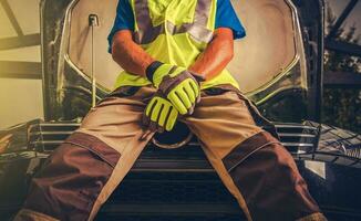 Mechanic man working on automobile photo