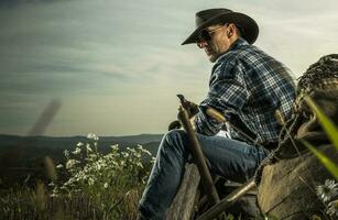 American Cowboy Enjoying Free Time on His Countryside Ranch photo