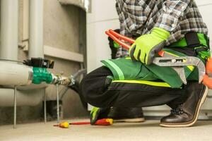 Plumbing Contractor Doing Necessary Fixes To the Heating Installation photo