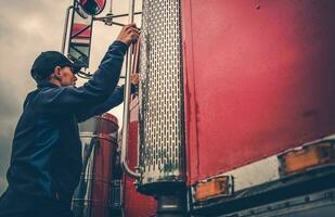 Truck Driver Getting Into Truck photo