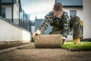 Landscaper Installing Natural Grass Turf photo