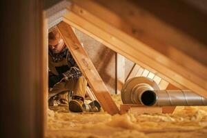 Air Ventilation Installer Working in Attic photo