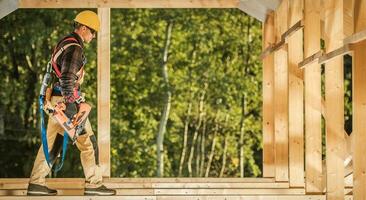 Construction Contractor Carpenter with Nail Gun in His Hand photo