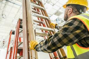 Worker Taking a Ladder To Work at Heights photo