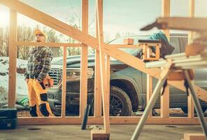 Contractor Worker, His Pickup Truck and the Construction Site photo