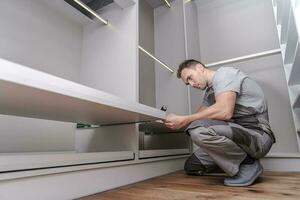 Men Assembling Closet Furnitures photo