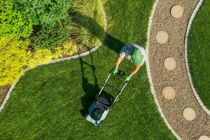 Gardener Mowing Backyard Garden Grass Aerial View. photo