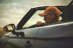 Caucasian Men Driving His Convertible Car photo