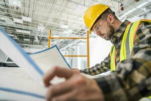 Construction Site Supervisor Taking Quick Look on a Blueprint photo