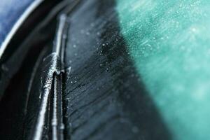 Car Windshield and Wiper Covered by Frost and Ice photo