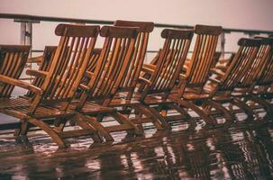 Empty and Wet Wooden Cruise Ship Deckchairs photo