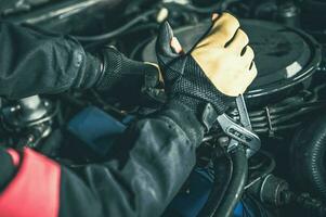 Car Mechanic Working with Gasoline Engine Problem photo