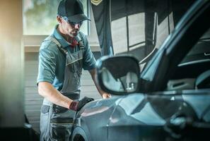 Car Mechanic Fixing Vehicle photo