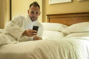 Man Checking His Social Media Profiles Before Going to Sleep photo