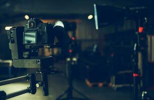 Digital Video Camera Attached to Automatic Jib Arm Inside a Studio photo