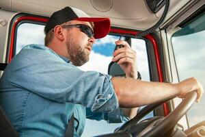 Truck Driver Taking Conversation Using CB Radio photo