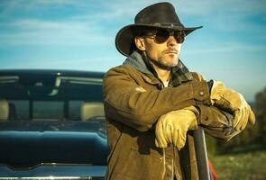 Caucasian Rancher Wearing Cowboy Hat and Sunglasses photo