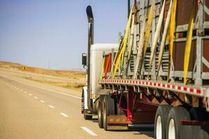 Semi Truck Trailer Oversize Cargo Secured with Lashing Straps photo