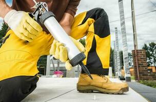 Professional Worker Using Outdoor Concrete Silicone photo