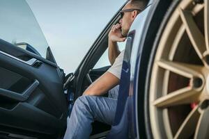 Men Making Road Assistance Phone Call From His Exotic Car photo