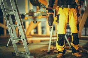 Construction Contractor Worker with a Nail Gun in His Hand photo