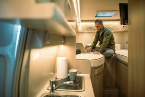 Men Working on His Laptop From His Camper Van photo