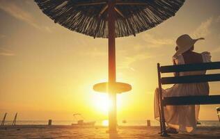 Retired Caucasian Woman Enjoying Tropical Beach Sunset photo