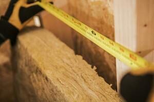 Carpenter Measuring Area With Tape Measure. photo