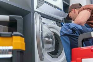 Technician Repairs Broken Washing Machine photo