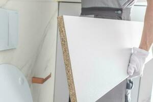 Worker Assembling Bathroom Furnitures photo