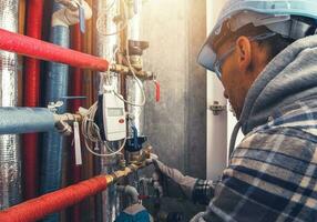 Heating Technician Making Final Check of the System photo