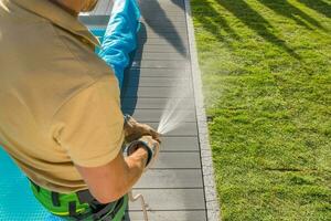 Caucasian Man Watering Newly Restored Garden Lawn. photo