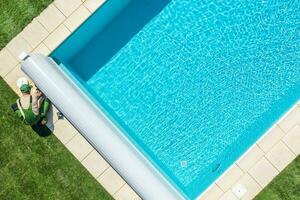 Swimming Pool Technician Cleaning Skimmer Filter photo