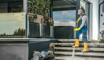 Caucasian Homeowner Pressure Washing His Garden Paths photo