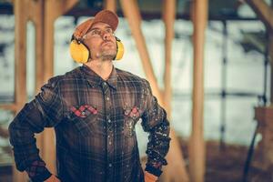 Construction Contractor Wearing Noise Reduction Headphones photo