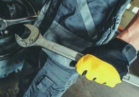 Professional Mechanic with Iron Wrench in His Hand photo