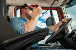 Semi Truck Lorry Driver Talking on CB Radio photo