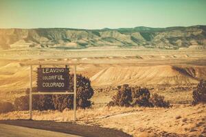 Leaving Colorful Colorado Utah Border Sign photo