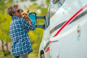 Retired Woman on the Road Trip with Her Dog photo