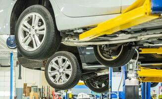 Modern Cars on Automotive Lifts In an Auto Service photo